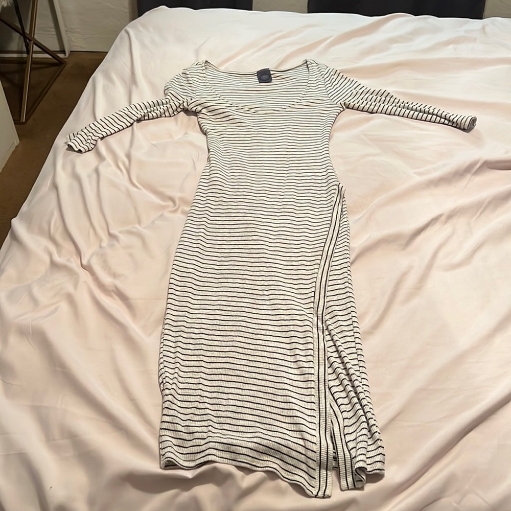 Mid length striped dress, high slit, low cut.